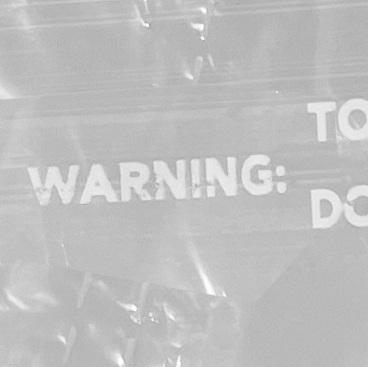 Close up of 21x4x38 .5 Mil Clear Plastic Garment Bags and Dry Cleaning Bags on Rolls for Slacks and Shirts Suffocation Warning