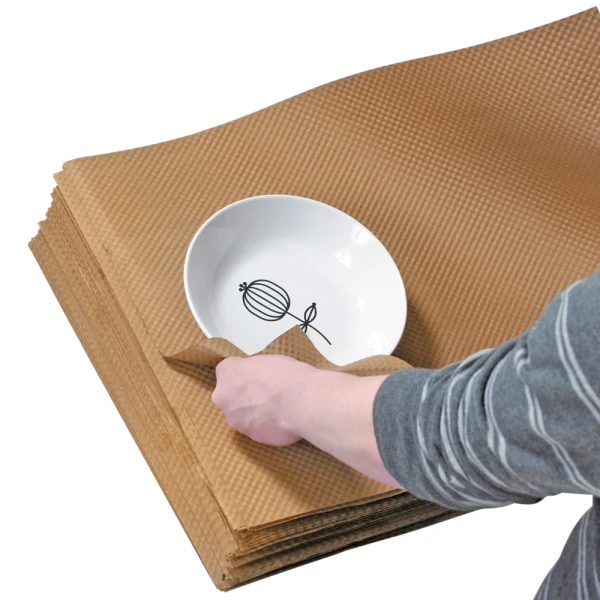 Kraft 24 x 36 Indented Paper Sheets protecting white bowl