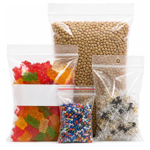 Zipper Locking Bags Four clear zip-lock bags in graduated sizes filled with candy, beans, beads, and hardware.