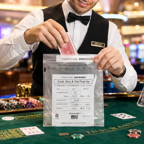 Security and Tamper-Evident Packaging Casino attendant sealing playing cards into a tamper-evident security bag at a table game