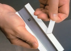 Hands removing liner of Double-Sided Foam Tape